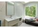 Bathroom featuring modern floating sink, large window, tile wall, and bench seat at 1760 Little Willeo Rd, Marietta, GA 30068