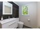 Modern bathroom with a floating vanity, sleek fixtures, and a dark accent wall at 1760 Little Willeo Rd, Marietta, GA 30068