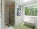 Shower room with large window overlooking wooded backyard, bench, and unique decor at 1760 Little Willeo Rd, Marietta, GA 30068