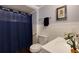 Bright bathroom featuring modern white vanity, blue shower curtain and decorative accents at 1760 Little Willeo Rd, Marietta, GA 30068