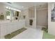Bathroom with double vanity, large mirror, white cabinets, and walk-in shower with patterned curtain at 1760 Little Willeo Rd, Marietta, GA 30068