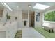 Bright bathroom features double vanity, walk-in shower, skylight, bench, and large window with wooded view at 1760 Little Willeo Rd, Marietta, GA 30068