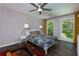 Bedroom with ceiling fan, two windows with yellow curtains, and dark wood floors at 1760 Little Willeo Rd, Marietta, GA 30068