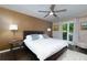 Warm bedroom with a ceiling fan, side tables, and natural light from the window at 1760 Little Willeo Rd, Marietta, GA 30068