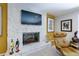 Close up on stone fireplace in living room with mounted tv and ergonomic chair at 1760 Little Willeo Rd, Marietta, GA 30068