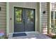Close up of the front door featuring decorative glass and side lights with manicured landscaping at 1760 Little Willeo Rd, Marietta, GA 30068
