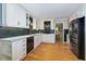 Modern kitchen with white cabinets, stainless steel appliances, and hardwood floors at 1760 Little Willeo Rd, Marietta, GA 30068