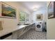 Bright laundry room with ample counter space, sink, and patterned tile flooring at 1760 Little Willeo Rd, Marietta, GA 30068