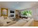 Bright living room features a stone fireplace, large windows, and comfortable white sectional sofa at 1760 Little Willeo Rd, Marietta, GA 30068