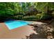 Backyard pool with diving board, set against the backdrop of a home and surrounding greenery at 1760 Little Willeo Rd, Marietta, GA 30068