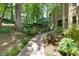 Beautiful walkway leading to the house with mature trees, shrubs, and landscaped yard at 1760 Little Willeo Rd, Marietta, GA 30068
