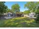 Large backyard with a shed, garden beds, carport, and fenced perimeter at 1841 Thompson Ave, Atlanta, GA 30344