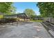Large backyard with a covered patio, storage area, and garden boxes at 1841 Thompson Ave, Atlanta, GA 30344