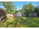 Expansive backyard with lush green grass, a storage shed, and a wooden privacy fence at 1841 Thompson Ave, Atlanta, GA 30344
