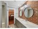Bathroom features a double sink vanity with a brick accent wall at 1841 Thompson Ave, Atlanta, GA 30344