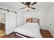 Bedroom features hardwood floors, ceiling fan, and white sliding door at 1841 Thompson Ave, Atlanta, GA 30344