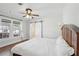 Bright bedroom featuring a ceiling fan, white walls, and hardwood floors at 1841 Thompson Ave, Atlanta, GA 30344