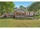 Charming brick home with a covered front porch and a well-maintained lawn at 1841 Thompson Ave, Atlanta, GA 30344