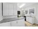 Updated kitchen with white cabinetry, granite counters and stainless steel appliances at 1841 Thompson Ave, Atlanta, GA 30344