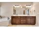 Bathroom features a double sink vanity with a tub and shower in the background at 204 Arthur Hills Dr, Acworth, GA 30101
