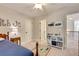 Well-lit bedroom featuring carpet flooring, neutral decor, and modern ceiling fan at 204 Arthur Hills Dr, Acworth, GA 30101