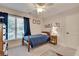 A cozy bedroom with carpet flooring, blue curtains, and a wooden bed frame at 204 Arthur Hills Dr, Acworth, GA 30101