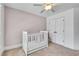 Comfortable Bedroom with a white crib, ample closet space, and neutral decor at 204 Arthur Hills Dr, Acworth, GA 30101