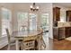 Charming breakfast nook with wooden table, sunlit windows, and views of the screened-in porch at 204 Arthur Hills Dr, Acworth, GA 30101