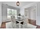 Dining room with white wainscoting, modern light fixture, and a view towards the front entry at 204 Arthur Hills Dr, Acworth, GA 30101