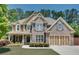 Beautiful brick-and-siding two-story home with a manicured lawn and a three-car garage at 204 Arthur Hills Dr, Acworth, GA 30101