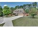 Beautiful home with a spacious driveway, manicured lawn, mature trees, and a two-car garage at 204 Arthur Hills Dr, Acworth, GA 30101