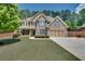 Inviting two-story home with a brick and siding facade, lush landscaping, and an attached two-car garage at 204 Arthur Hills Dr, Acworth, GA 30101