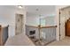 Upstairs hallway with carpet and decorative railing overlooking the living room below at 204 Arthur Hills Dr, Acworth, GA 30101