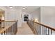 Upper hallway featuring carpet, a dark railing and a glimpse into well-lit bedrooms at 204 Arthur Hills Dr, Acworth, GA 30101