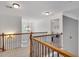 Bright upstairs hallway with carpeted floors, dark metal railings, and abundant natural light at 204 Arthur Hills Dr, Acworth, GA 30101