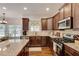 Kitchen features stainless appliances, dark cabinets, granite counters, and hardwood floors at 204 Arthur Hills Dr, Acworth, GA 30101