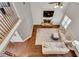 Open-concept living room with fireplace, TV, hardwood flooring, and comfortable seating at 204 Arthur Hills Dr, Acworth, GA 30101