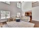 Sunlit living room featuring hardwood floors, a large sofa, and open access to the kitchen at 204 Arthur Hills Dr, Acworth, GA 30101