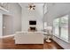 Bright living room with a stone fireplace, hardwood floors, and large windows at 204 Arthur Hills Dr, Acworth, GA 30101