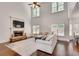 Bright living room with a stone fireplace, large windows, and hardwood floors at 204 Arthur Hills Dr, Acworth, GA 30101