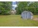 Spacious backyard view showing a storage shed on a grassy lot at 2416 Hurt Sw Rd, Marietta, GA 30008