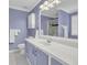 Bright bathroom features a double sink vanity, a large mirror, and a shower at 2416 Hurt Sw Rd, Marietta, GA 30008