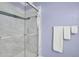 Modern bathroom featuring new shower glass and a sleek towel rack with white towels at 2416 Hurt Sw Rd, Marietta, GA 30008