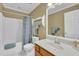 Bathroom featuring white cabinets and countertops, with a shower-tub combo and blue shower curtain at 2416 Hurt Sw Rd, Marietta, GA 30008