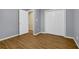 Bedroom with wood-look floors, gray walls, and a closet with white bi-fold doors at 2416 Hurt Sw Rd, Marietta, GA 30008
