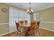Dining area with a chandelier and large windows providing natural light at 2416 Hurt Sw Rd, Marietta, GA 30008