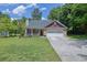 Charming single-Gathering home with well-manicured lawn, flowerbeds, and a two-car garage at 2416 Hurt Sw Rd, Marietta, GA 30008