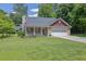 Charming single-Gathering home with well-manicured lawn, flowerbeds, and a two-car garage at 2416 Hurt Sw Rd, Marietta, GA 30008