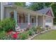 Charming front porch with a lovely garden and manicured flowerbed at 2416 Hurt Sw Rd, Marietta, GA 30008