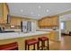 Kitchen with bar stool seating at the island, stainless appliances, and light wood cabinetry at 2416 Hurt Sw Rd, Marietta, GA 30008